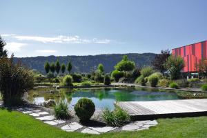 a pond in the middle of a garden at Hotel Die Zeit in Sankt Veit an der Glan