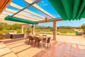 an outdoor patio with a table and chairs at Villa Son Bennasar by Slow Villas in Felanitx
