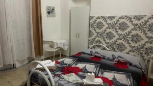 a bedroom with a bed with red roses on it at Ill Balcone sullo stretto in Reggio di Calabria