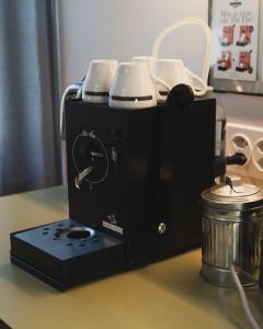 a coffee maker on a counter next to a pot at One Suite Hotel - Zollhaus in Bern