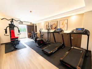 a gym with several treadmills and exercise bikes at Miloft Suvarnabhumi Airport Hotel in Lat Krabang
