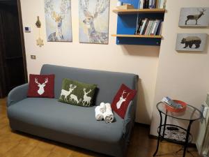 a couch with pillows on it in a living room at Appartamento Cedro - Centro Aprica - Park - WiFi in Aprica +39 photos