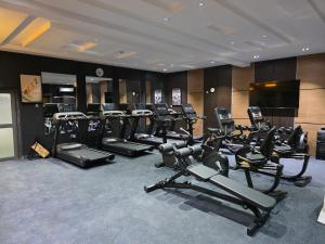 a gym with a bunch of exercise bikes and treadmills at Movela Hotels in Warri