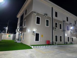 a large brick building with a lot of windows at night at Movela Hotels in Warri