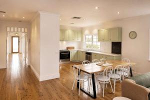 a kitchen and dining room with a table and chairs at Yarra Palms in Yarrawonga