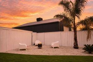 a group of chairs and a table with a candle at Yarra Palms in Yarrawonga