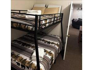 a room with two bunk beds with blankets and towels at River & Vine in Helen