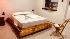 a bed sitting on a wooden platform in a room at Maison Studio indépendante in Nungwi