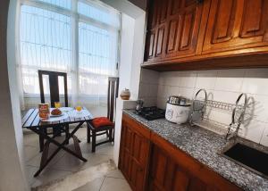 a kitchen with a table and a counter top at Appartement VIP centre ville in Toamasina