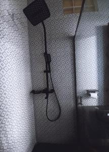 a shower in a bathroom with a shower head at Appartement VIP centre ville in Toamasina