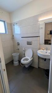 a bathroom with a toilet and a sink at Avea Accommodation in Madurai +45 photos