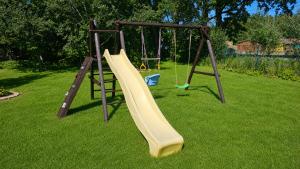 a playground with a slide and a swing at Paide Event Center Hostel in Prääma