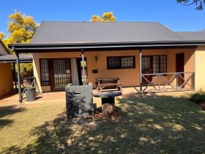 a house with a dog standing in front of it at Pendleberry Unit 85 in Warmbaths