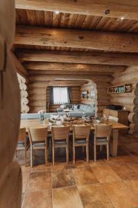 a wooden dining room with a table and chairs at Mei Zeit Hüttendorf in Turracher Hohe