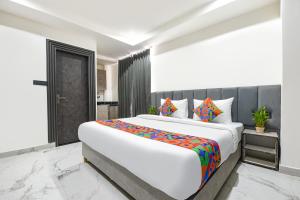 a bedroom with a large bed in a room at FabHotel The Silken Stay in Gurgaon