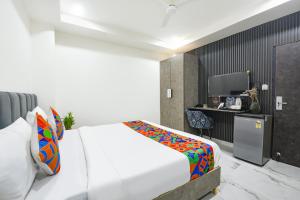 a bedroom with a white bed and a desk at FabHotel The Silken Stay in Gurgaon +33 photos