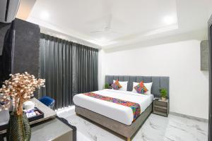 a bedroom with a large bed and a window at FabHotel The Silken Stay in Gurgaon