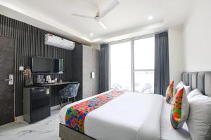 a hotel room with a bed and a television at FabHotel The Silken Stay in Gurgaon