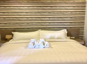 a group of towels sitting on top of a bed at ECL Travellers Inn in Nabas