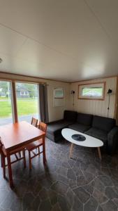 a living room with a couch and a table at Saltstraumen camping in Bodø