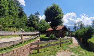 a wooden fence in front of a barn at Baita al sole in Faida