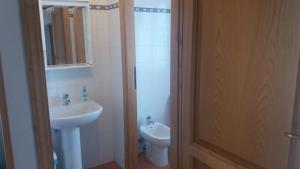 a bathroom with a sink and a toilet and a door at Agriturismo Sorripe in Montelaterone +33 photos