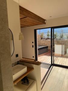 a room with a large sliding glass door with a porch at L'évasion in Saint-Jean-dʼArvey