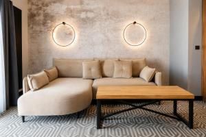 a living room with a couch and a coffee table at Lofft Hotel in Ciechanów