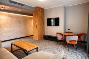 a living room with a table and chairs and a couch at Lofft Hotel in Ciechanów +91 photos