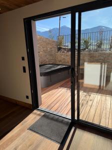 a sliding glass door with a view of a deck at L'évasion in Saint-Jean-dʼArvey