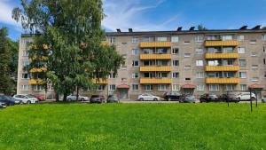 a large apartment building with cars parked in a park at Vilde Apartment in Tallinn