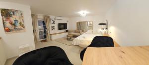 a bedroom with a bed and a table and chairs at Luni Studio Apartment with garden in Kaštela