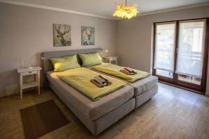 a bedroom with a bed with two towels on it at Ferienwohnung Habermehl in Oppenau +8 photos