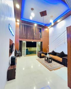 a large living room with a blue ceiling at Paradise Villa in Lonavala
