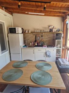 a kitchen with a table with four green plates on it at Bungalows Rea in Burgas +7 photos