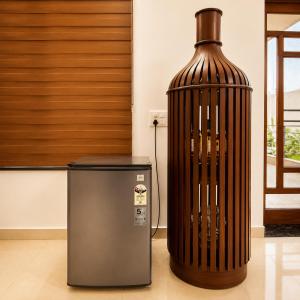 a large vase sitting next to a trash can at The Crown Resort in Sonīpat