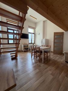 a kitchen and dining room with a table and chairs at Hotel a Restaurant Výpřež in Děčín