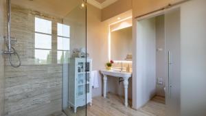 a bathroom with a sink and a shower at VILLA LA MONARCA 16, Emma Villas in Torrita di Siena