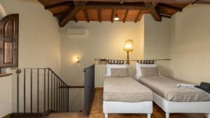 a room with two beds and a stair railing at VILLA LA MONARCA 16, Emma Villas in Torrita di Siena +54 photos