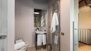 a small bathroom with a sink and a mirror at VILLA LA MONARCA 16, Emma Villas in Torrita di Siena
