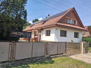 a house with a fence in front of it at Ponte Liptov in Liptovský Trnovec