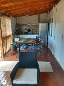 a kitchen and dining room with a table and a refrigerator at Bungalows Rea in Burgas