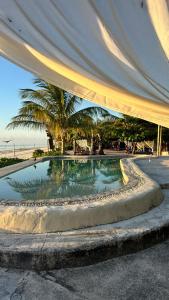 a small swimming pool with a tent over it at Lõst Soles Lodge in Jambiani +41 photos