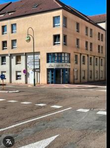 an empty street in front of a large building at Studio PARAY CENTRE LOGIS 12 in Paray-le-Monial