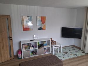a living room with a television and a white cabinet at Ponte Liptov in Liptovský Trnovec