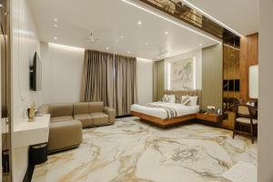 a hotel room with a bed and a couch at Bedi's Dream Land Hotel & Resort in Ayodhya +27 photos