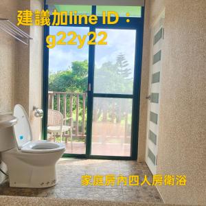 a bathroom with a toilet in front of a door at Summer Homestay in Kenting +53 photos