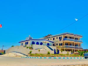 a large building on the side of a street at Blue House villa in Marsa Matruh