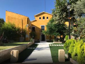 a building with a street light next to a sidewalk at Masía Can Trabal in Olerdola