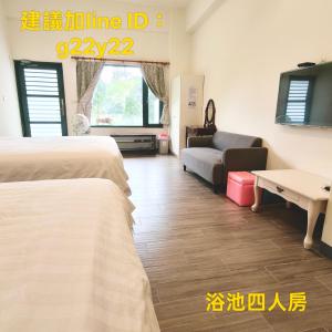 a hotel room with two beds and a couch at Summer Homestay in Kenting